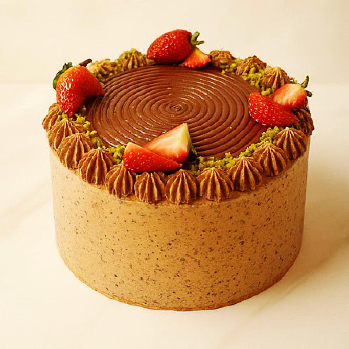 Chocolate cake with strawberry slices on a white background