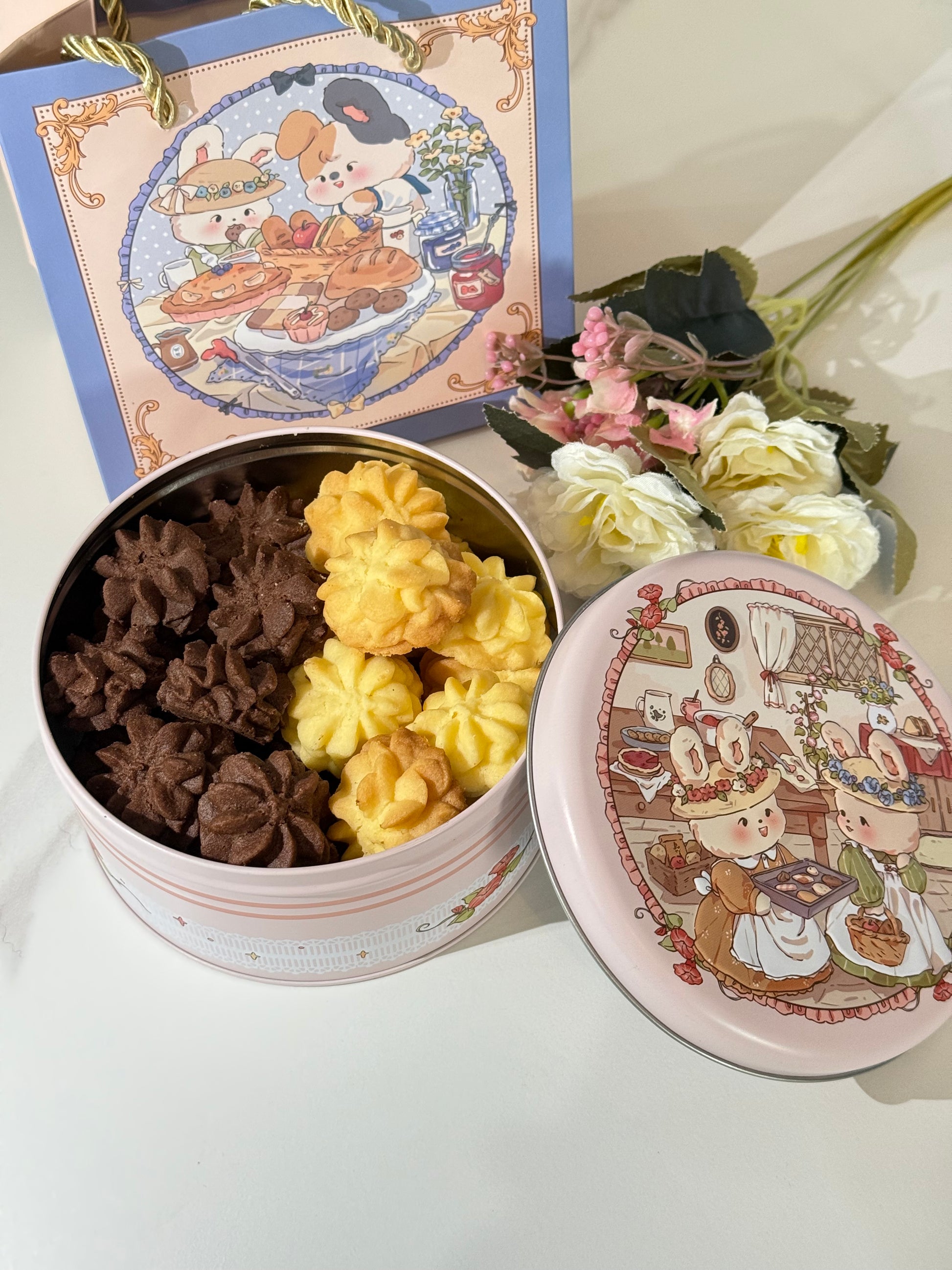 Decorative box with floral design on lid, containing assorted flowers.