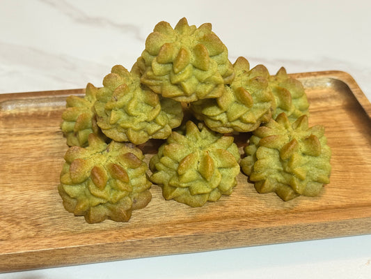 Green matcha cookies on a wooden tray