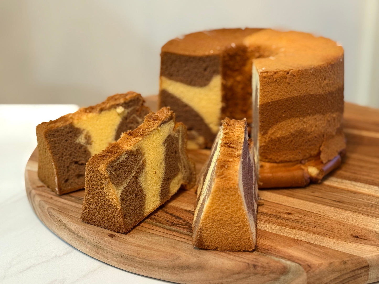 Marbled cake with slices on a wooden board