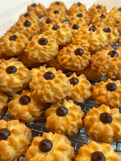 Pastries with chocolate chips on a cooling rack