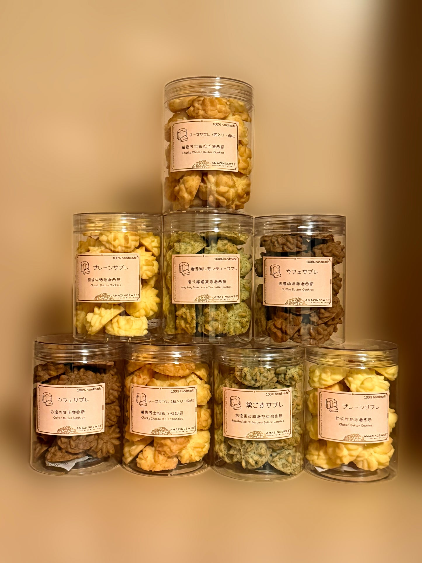 Stack of glass jars with snacks and labels on a beige background