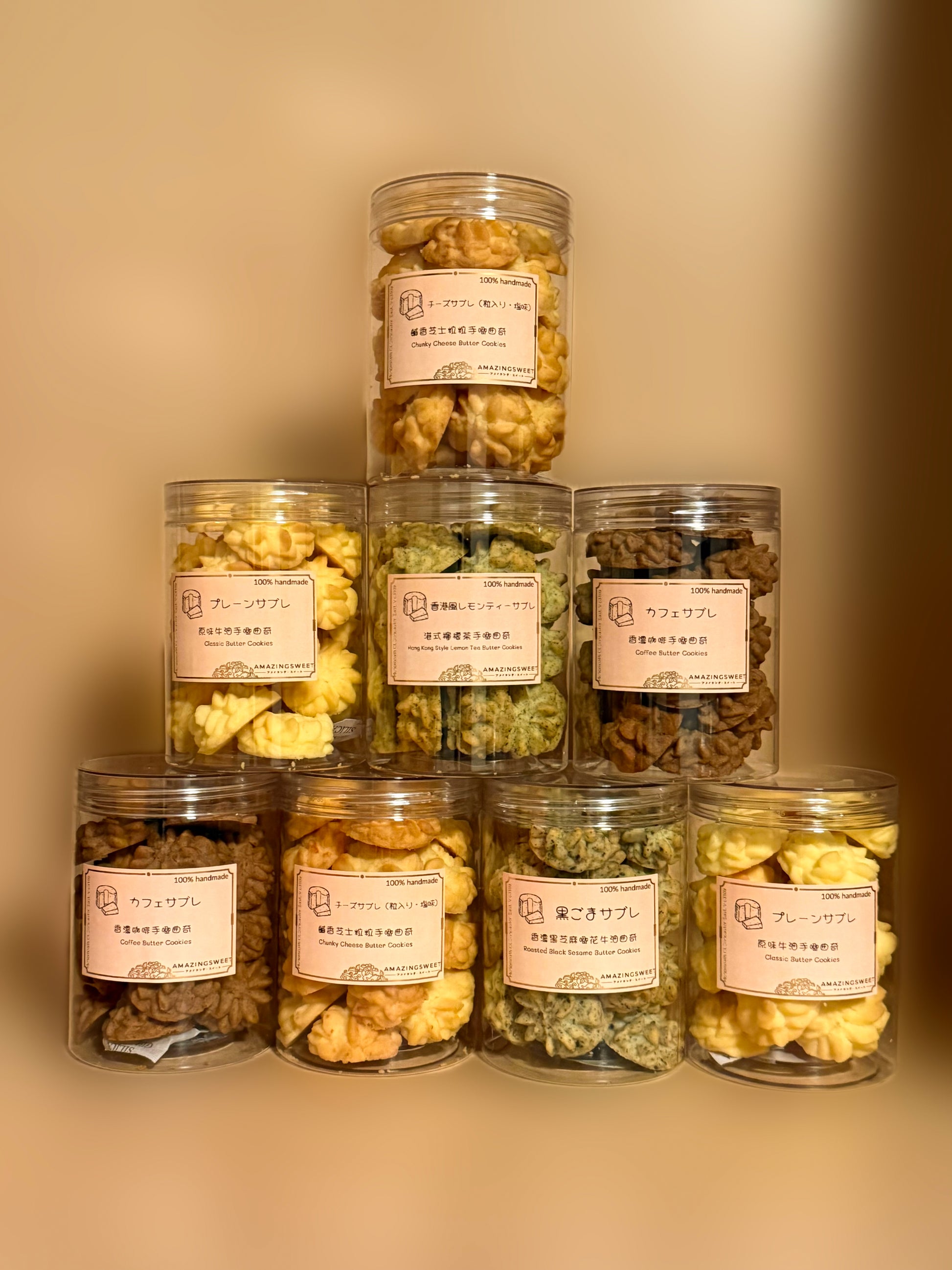 Stack of glass jars with snacks and labels on a beige background