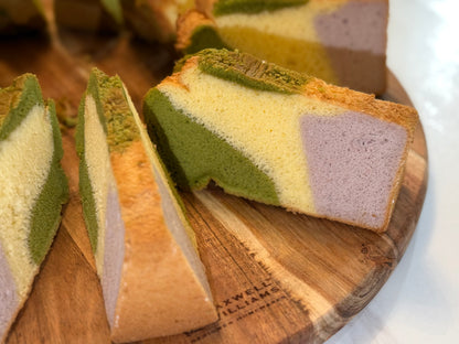 Colorful layered cake slices on a wooden board
