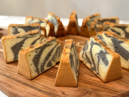 Marbled cake slices on a wooden board with a blurred background