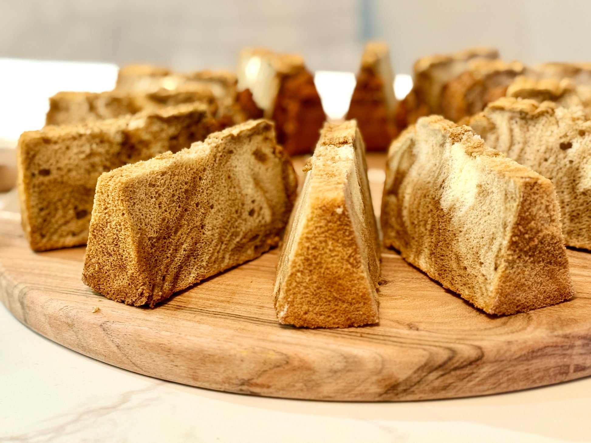 Slices of bread on a wooden cutting board with a blurred background