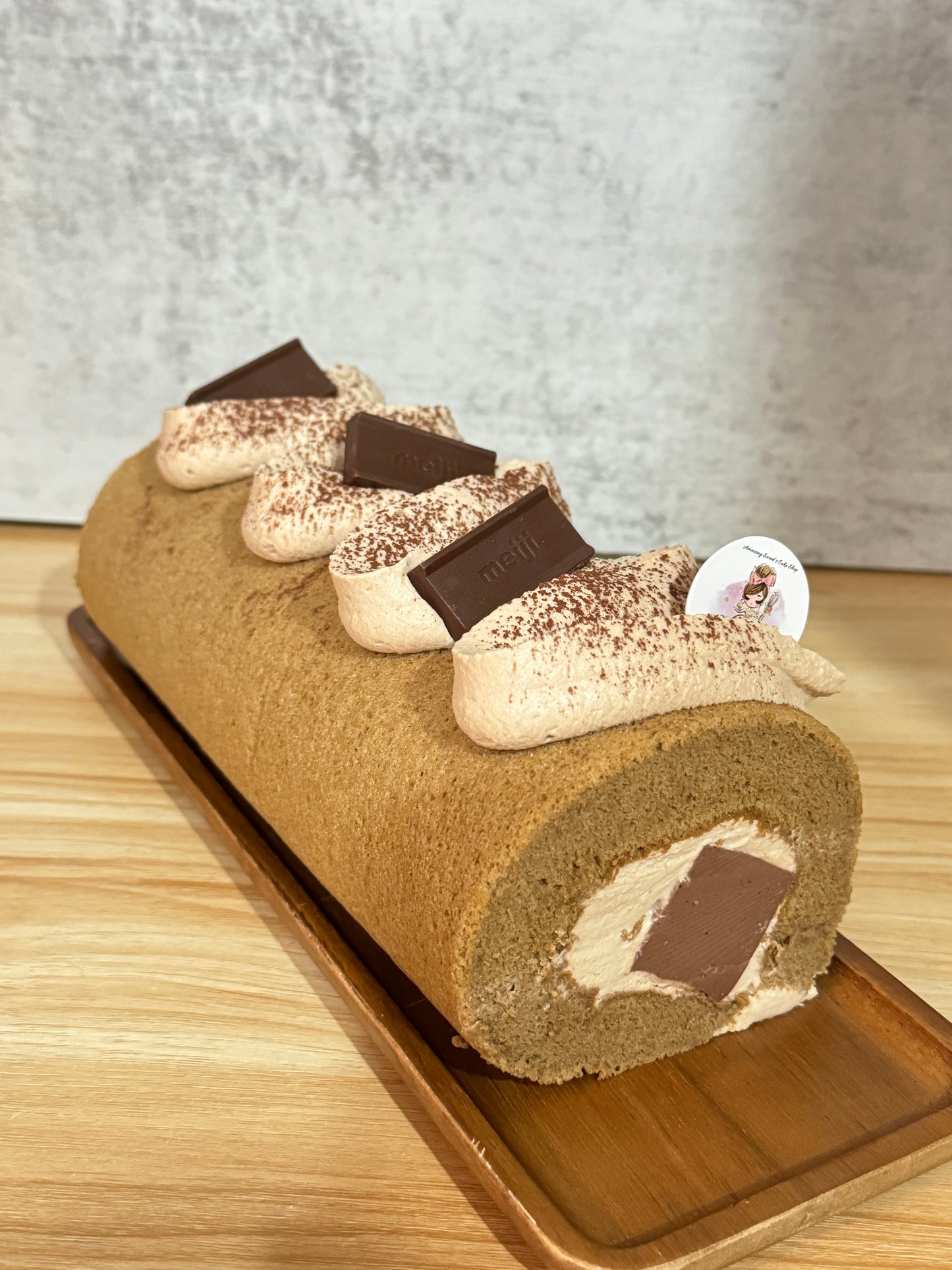 Chocolate roll cake with cream on a wooden board