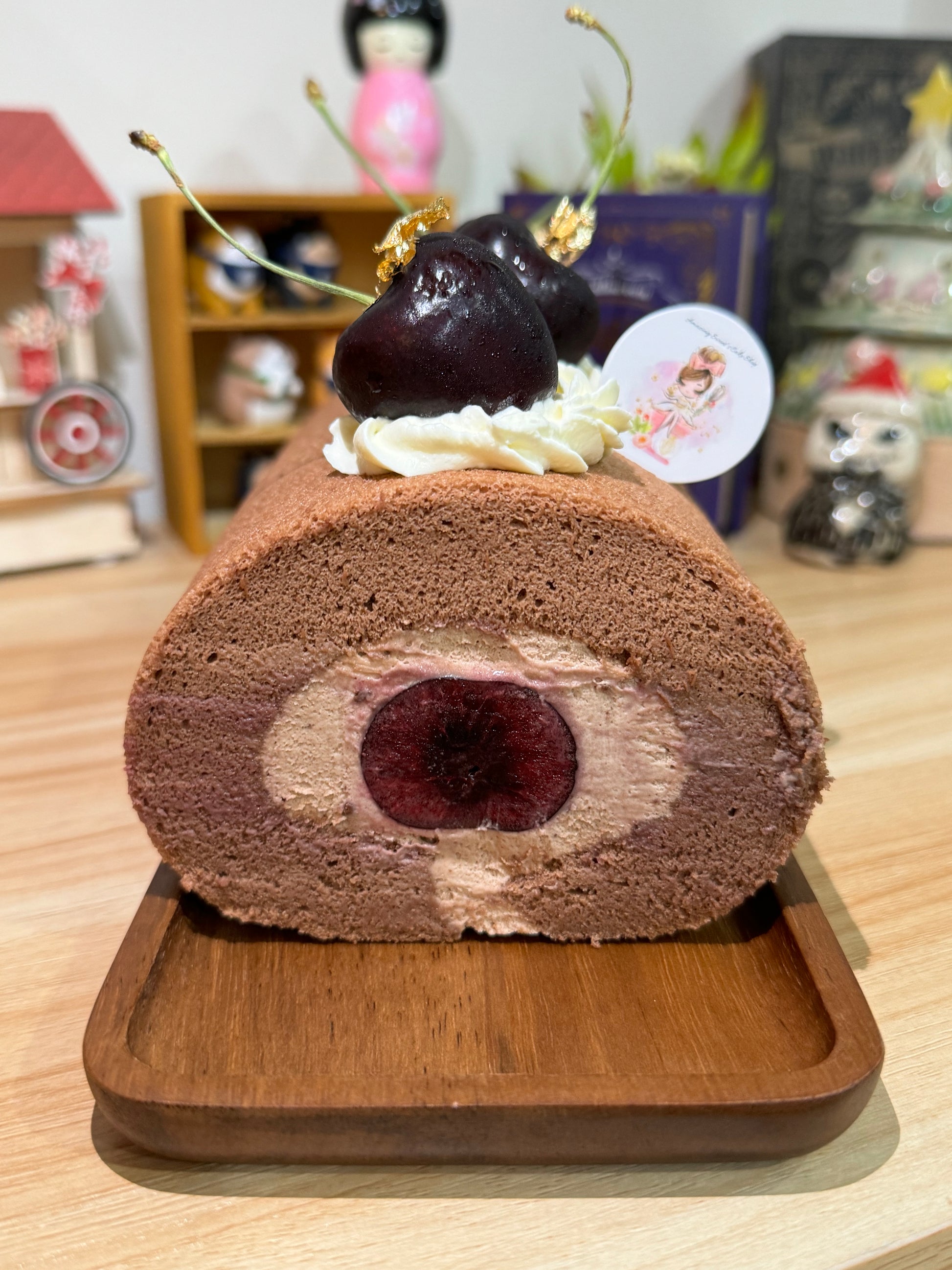 Cross-section of a layered cake on a wooden board with decorative elements.